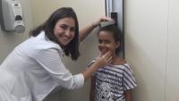 Doctor measuring a little girl's height